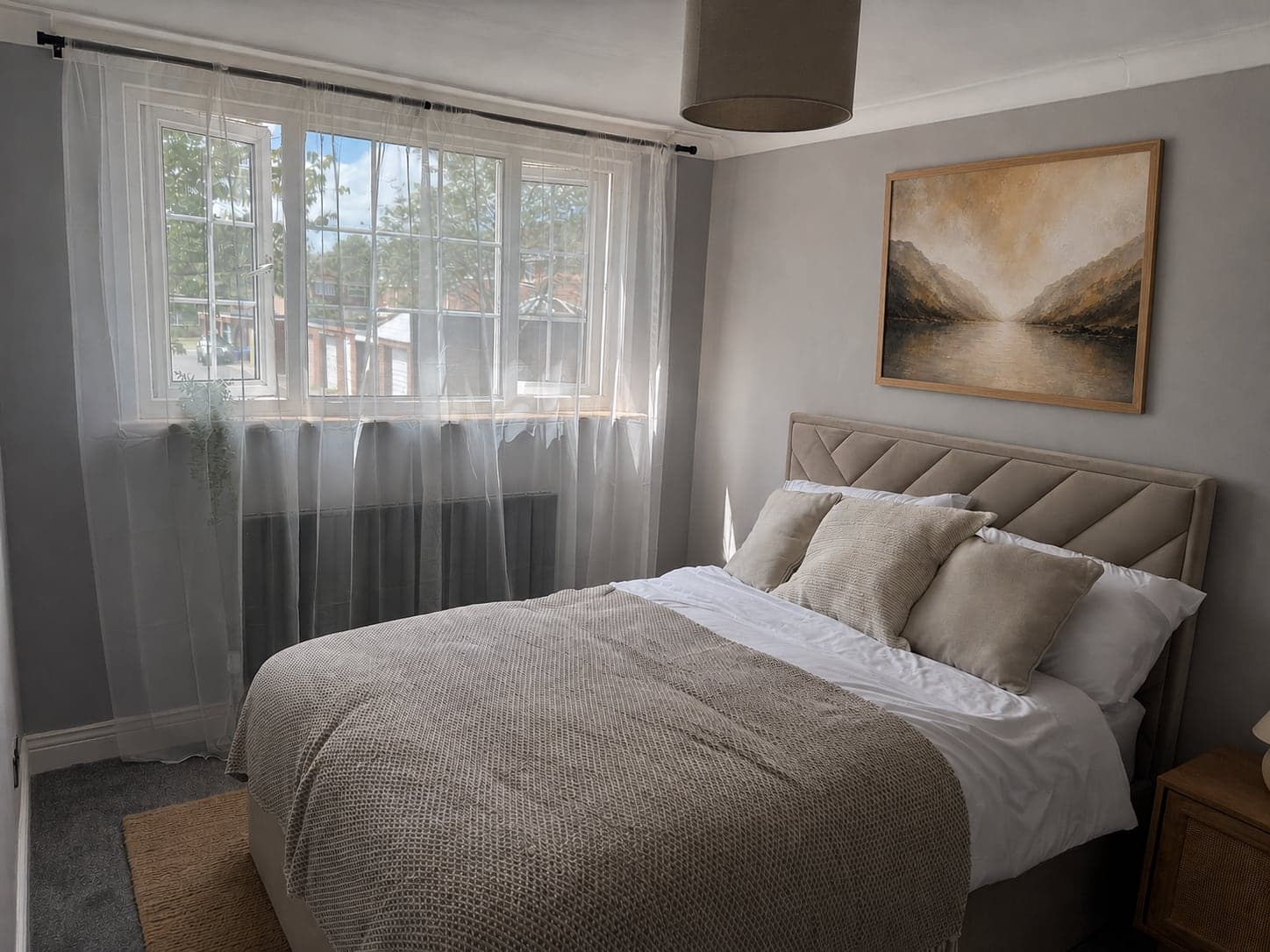 The Fjell & Fjord double bedroom at Nordic Spa House, a mountain-and-fjord print above the bed