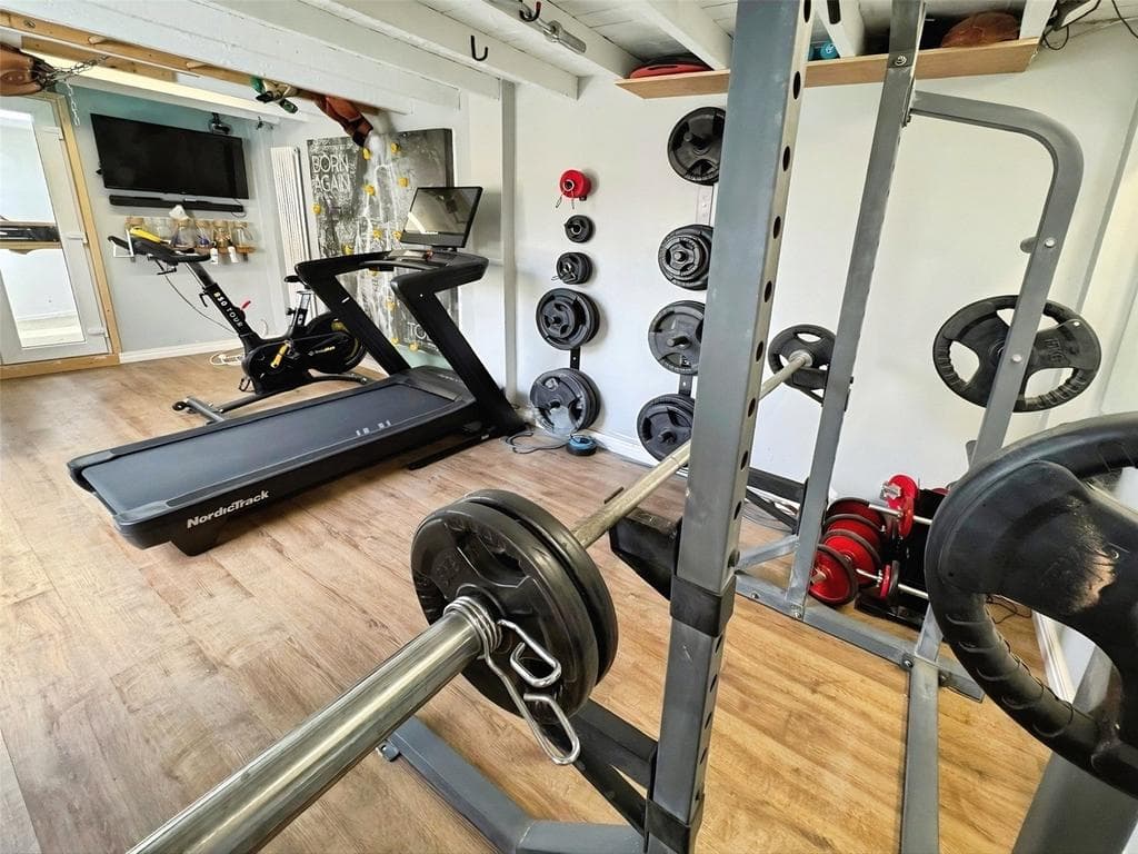 Home gym with squat rack and weights